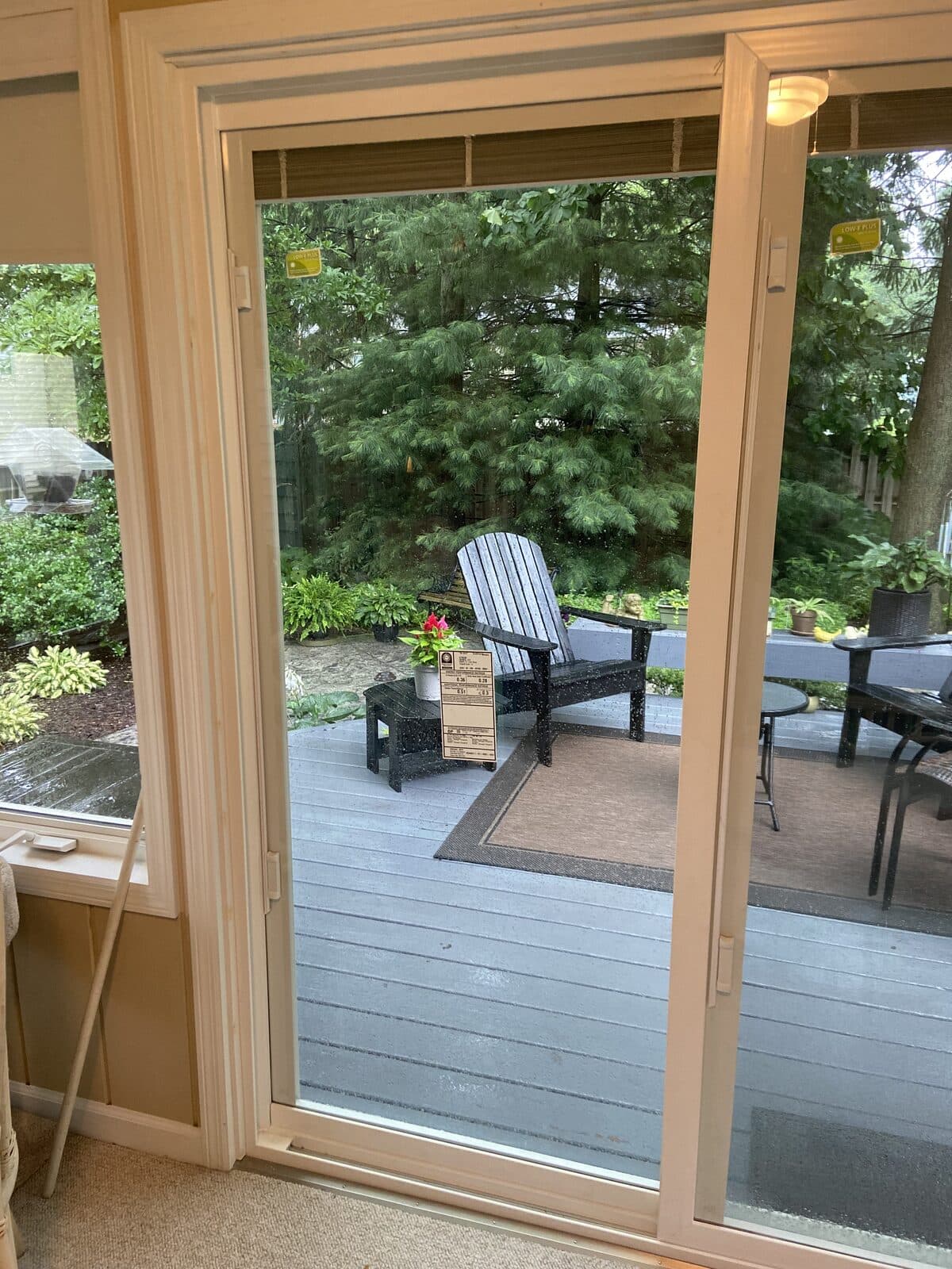 View through new slider to backyard patio with Adirondack chair